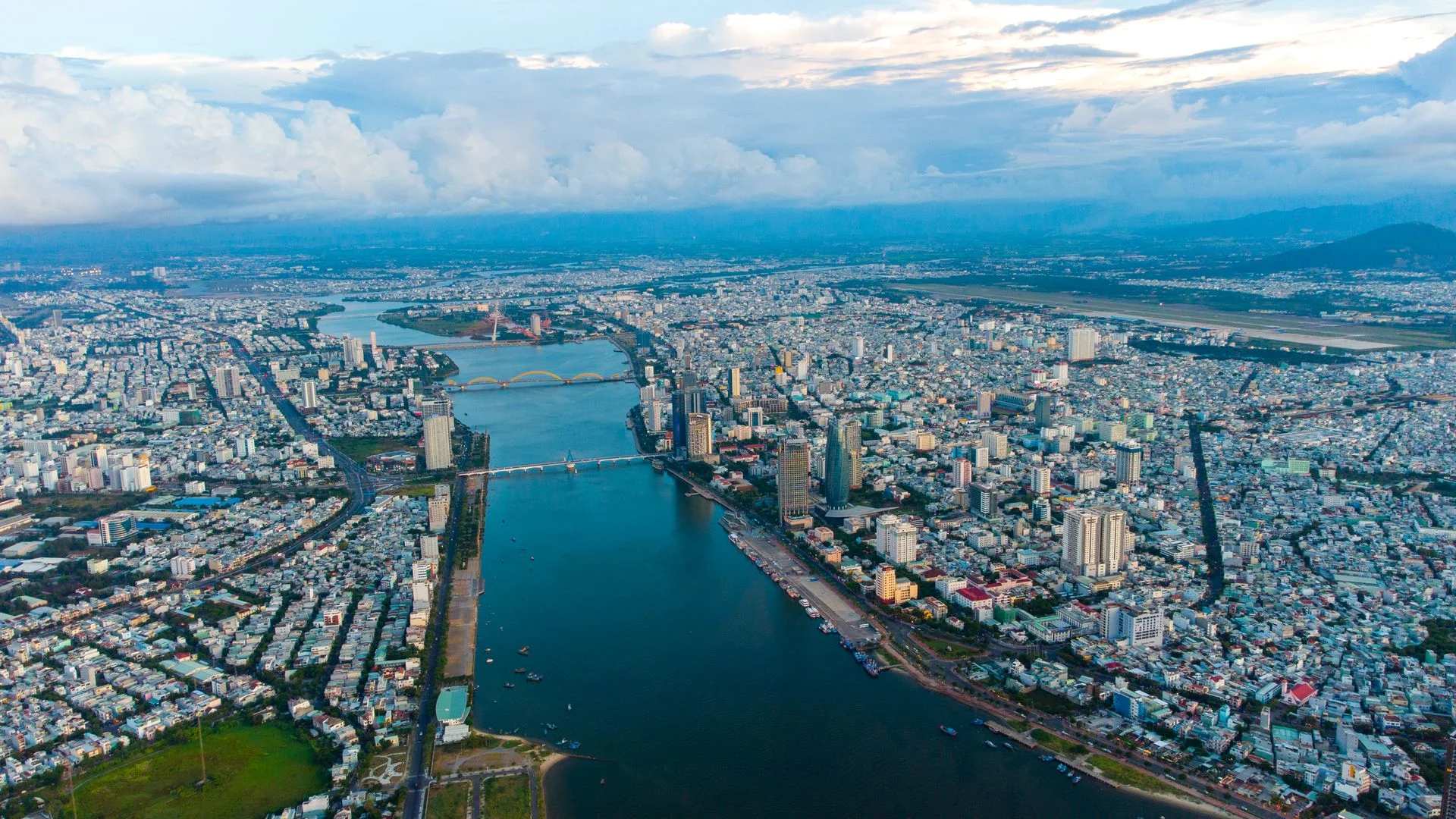 Five-star beachfront resorts and the riverfront skyline of Da Nang at dusk