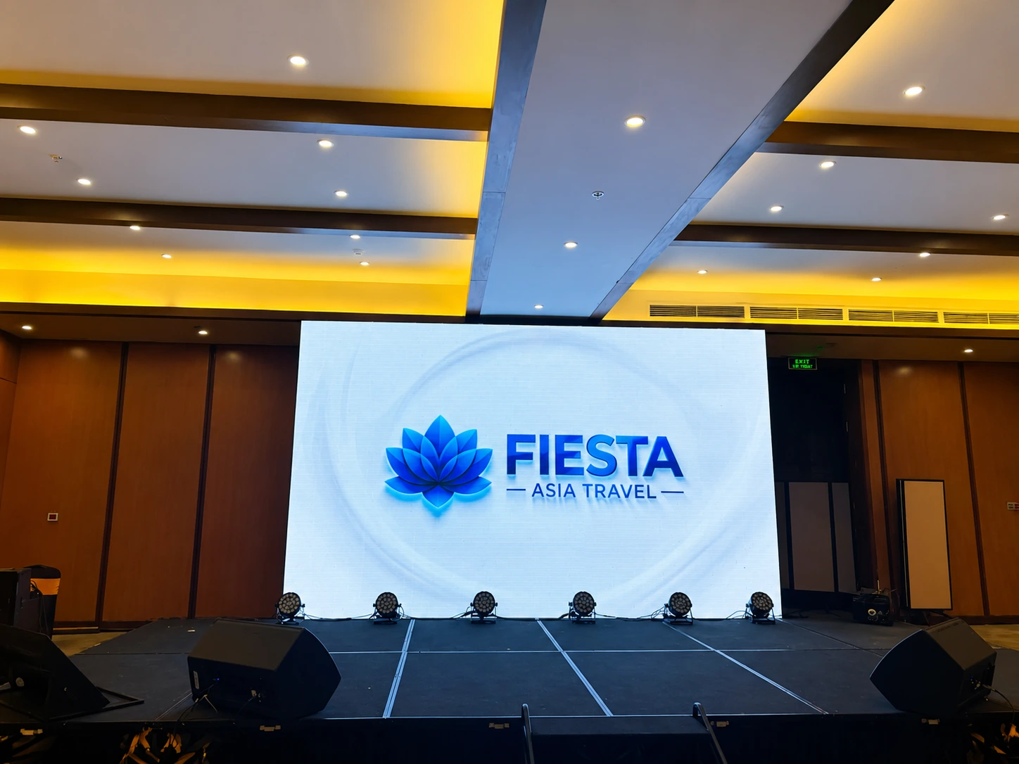 Event stage and LED backdrop branded for Fiesta Asia Travel at a conference venue in Vietnam — MICE and events by our Vietnam DMC
