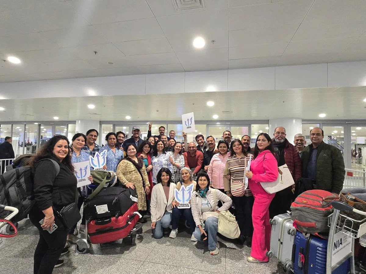 A travel group met in the arrivals hall of a Vietnam airport with their luggage trolleys