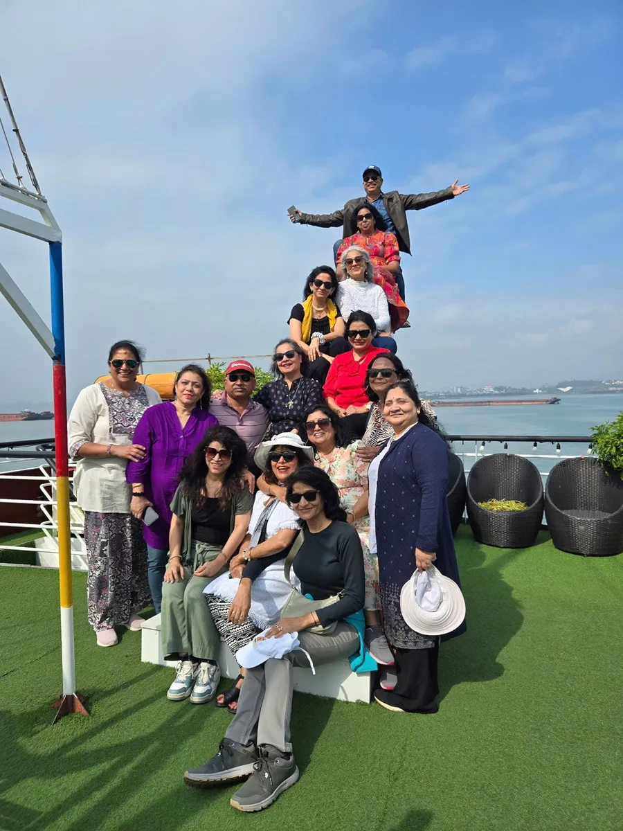 A travel group on the open deck of a boat during a day excursion off the Vietnamese coast