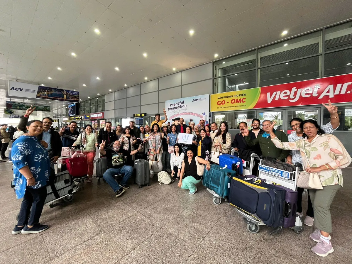 A travel group with their luggage at the airline check-in counters before their departure flight home