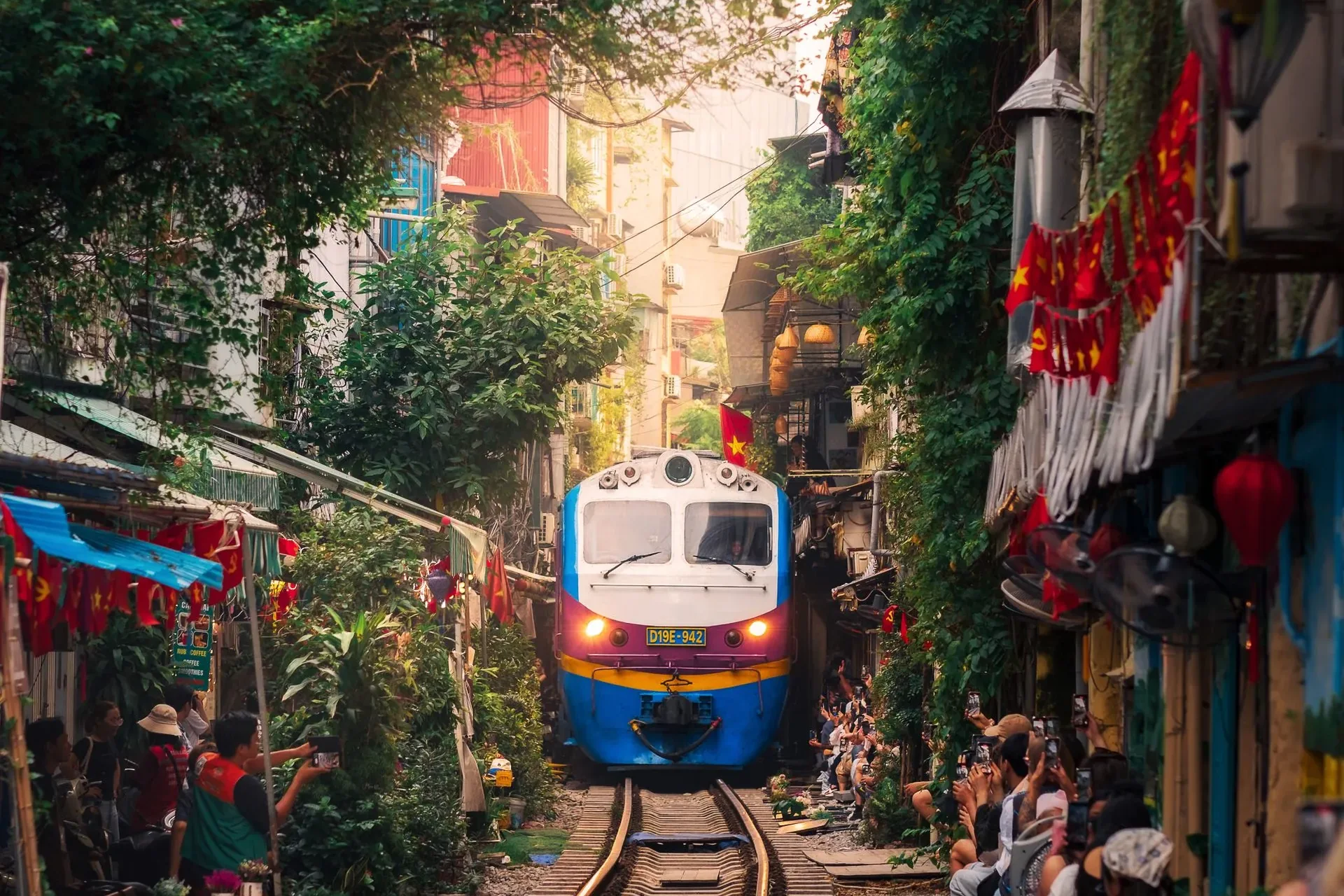 A train passing between the houses of Hanoi Train Street — Vintage Vietnam itinerary, Vietnam DMC by Fiesta Asia Travel