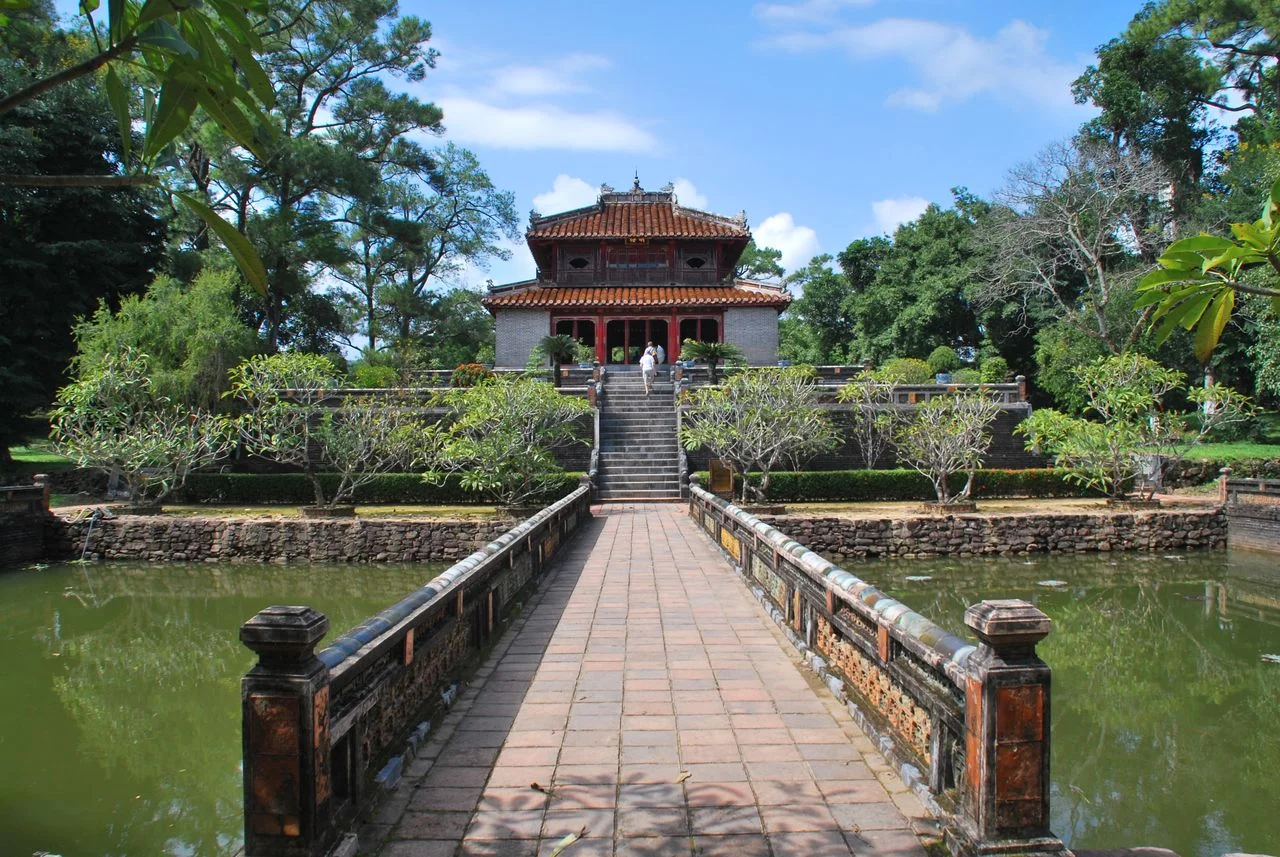 A royal tomb pavilion beside a lotus pond in Hue — Vietnam DMC