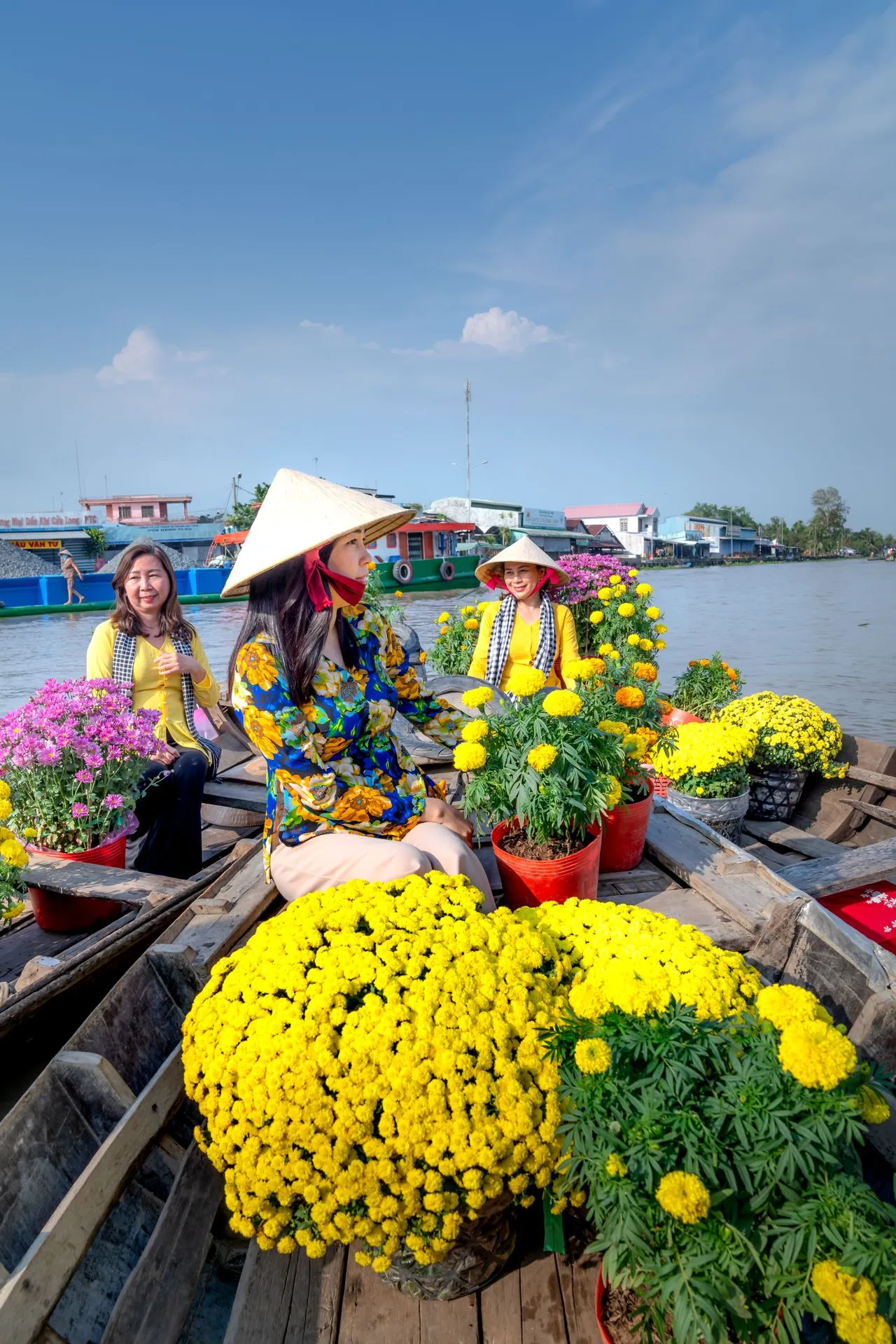 Boats laden with marigolds and chrysanthemums at a Mekong Delta floating flower market