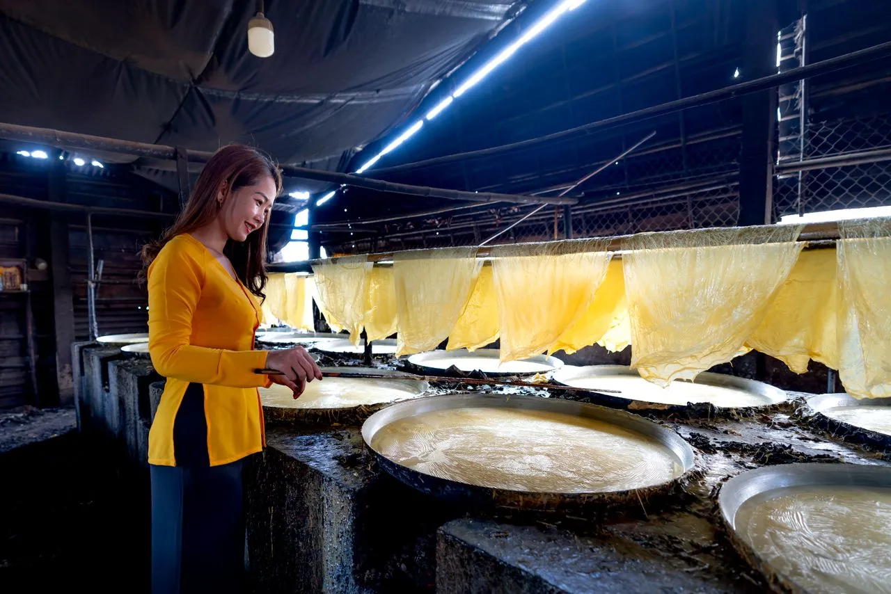 Fresh rice paper drying on racks at a banh trang workshop in the Mekong Delta
