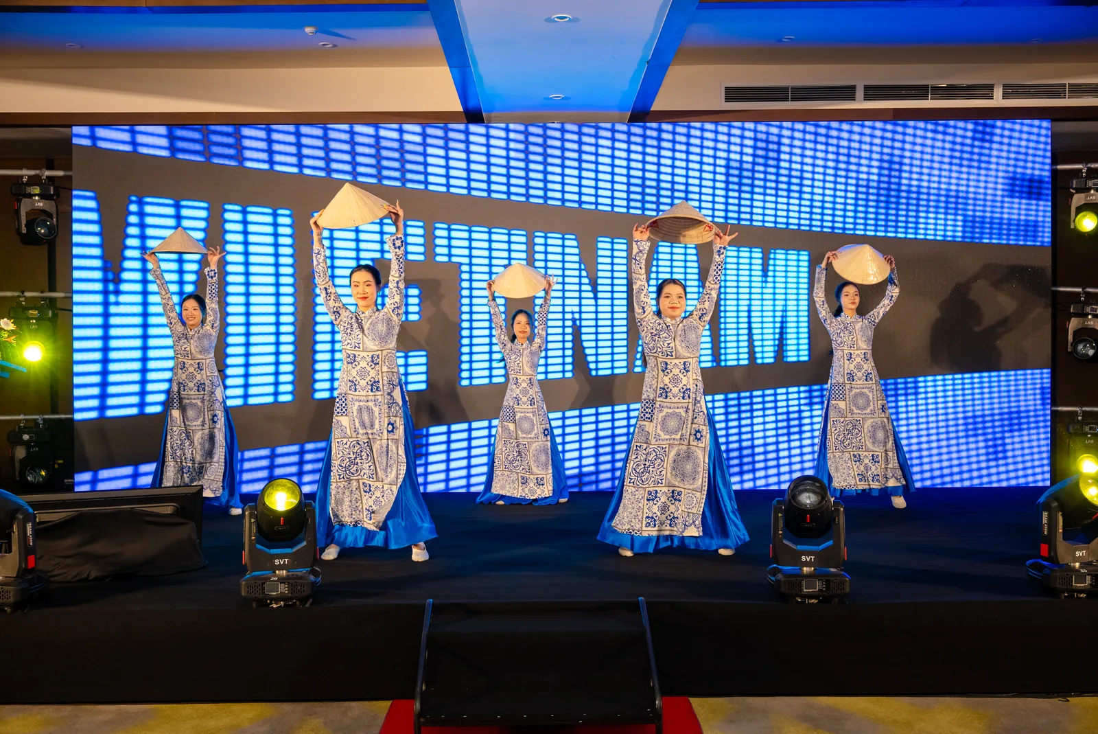 A traditional Vietnamese fan dance performance on stage at a Fiesta Asia MICE gala evening