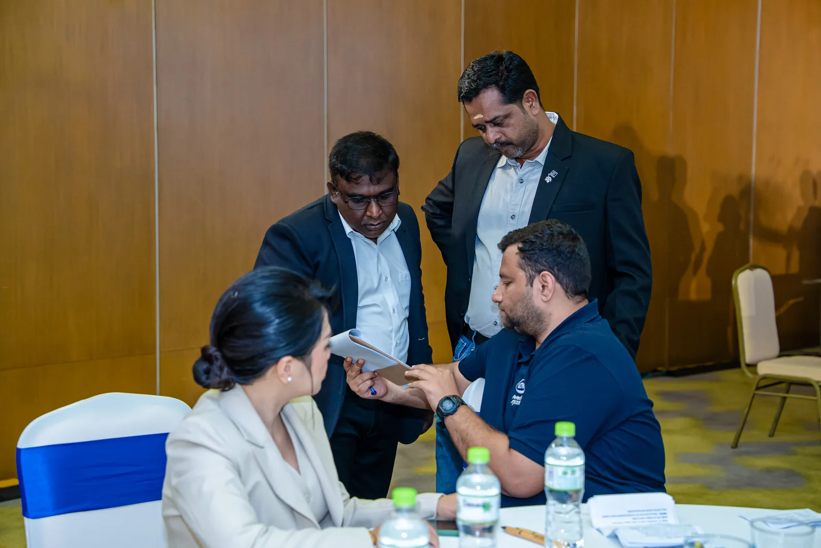 A Fiesta Asia coordinator briefing delegates at the registration desk during a MICE programme